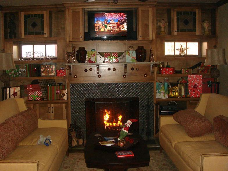 Lots of built-ins and a wood burning fireplace make this room cozy for the holiday season.