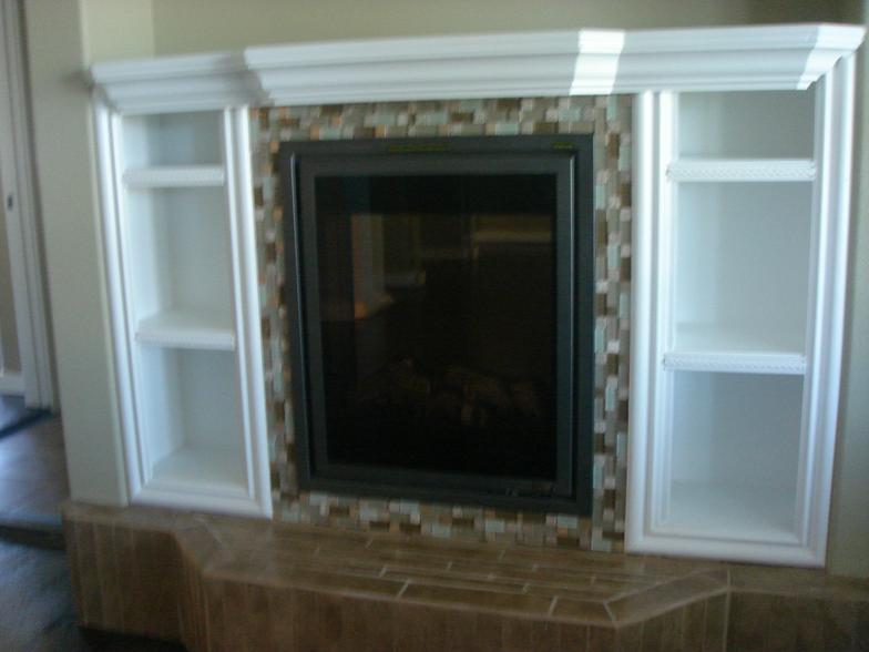 Space beside a fireplace can be used to store movies or display items.