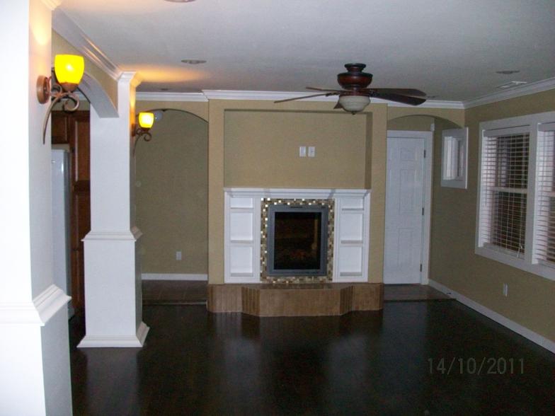 A custom tiled fireplace and hearth anchor this living room.