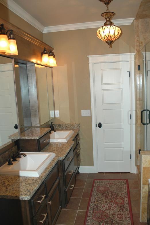 This bathroom retreat has granite counters, large square sinks, and great lighting.