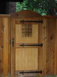 The black metal 'window' and hardware add visual interest to this gate.